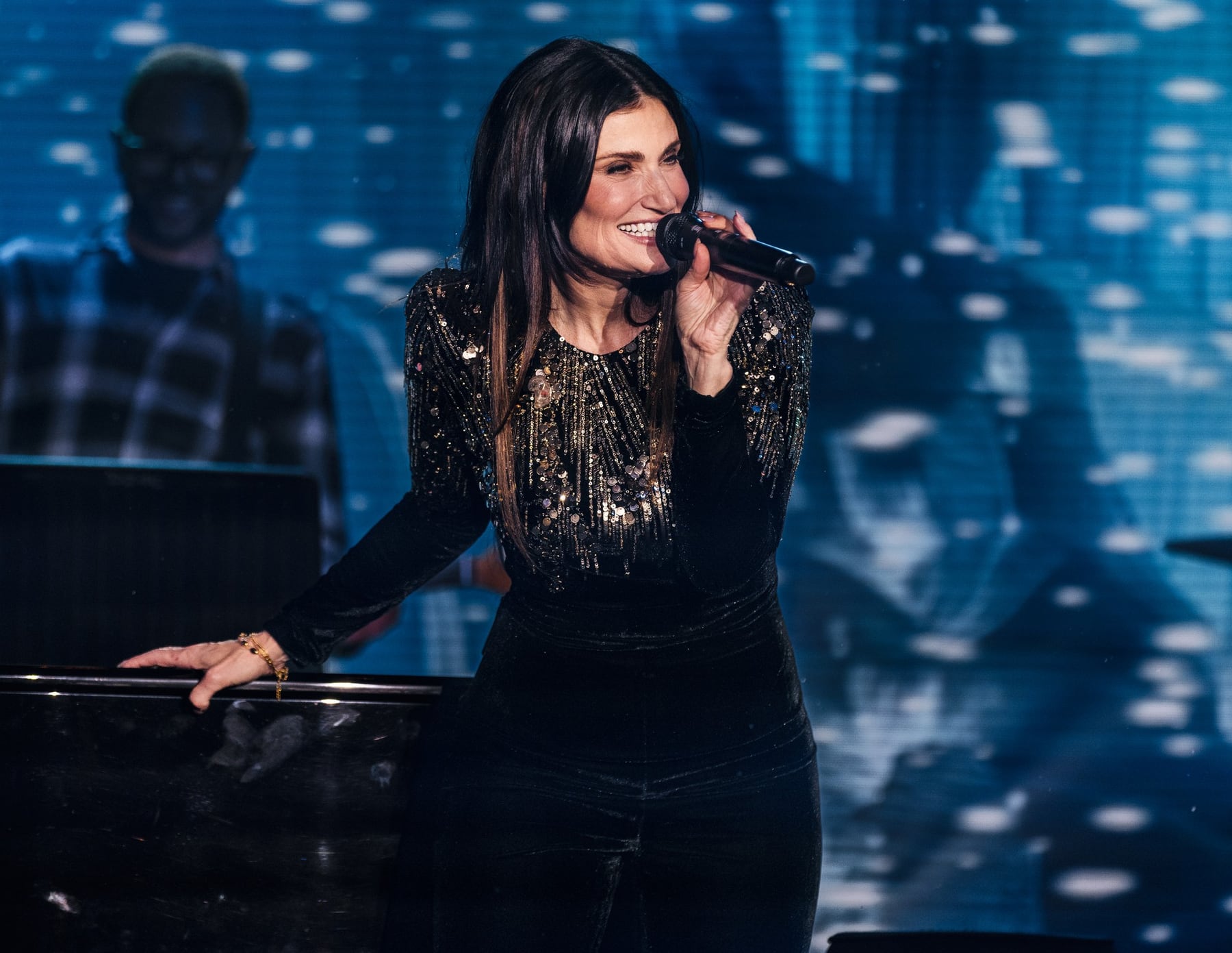 Idina Menzel singing during a Travelers corporate event performance in Amelia Island