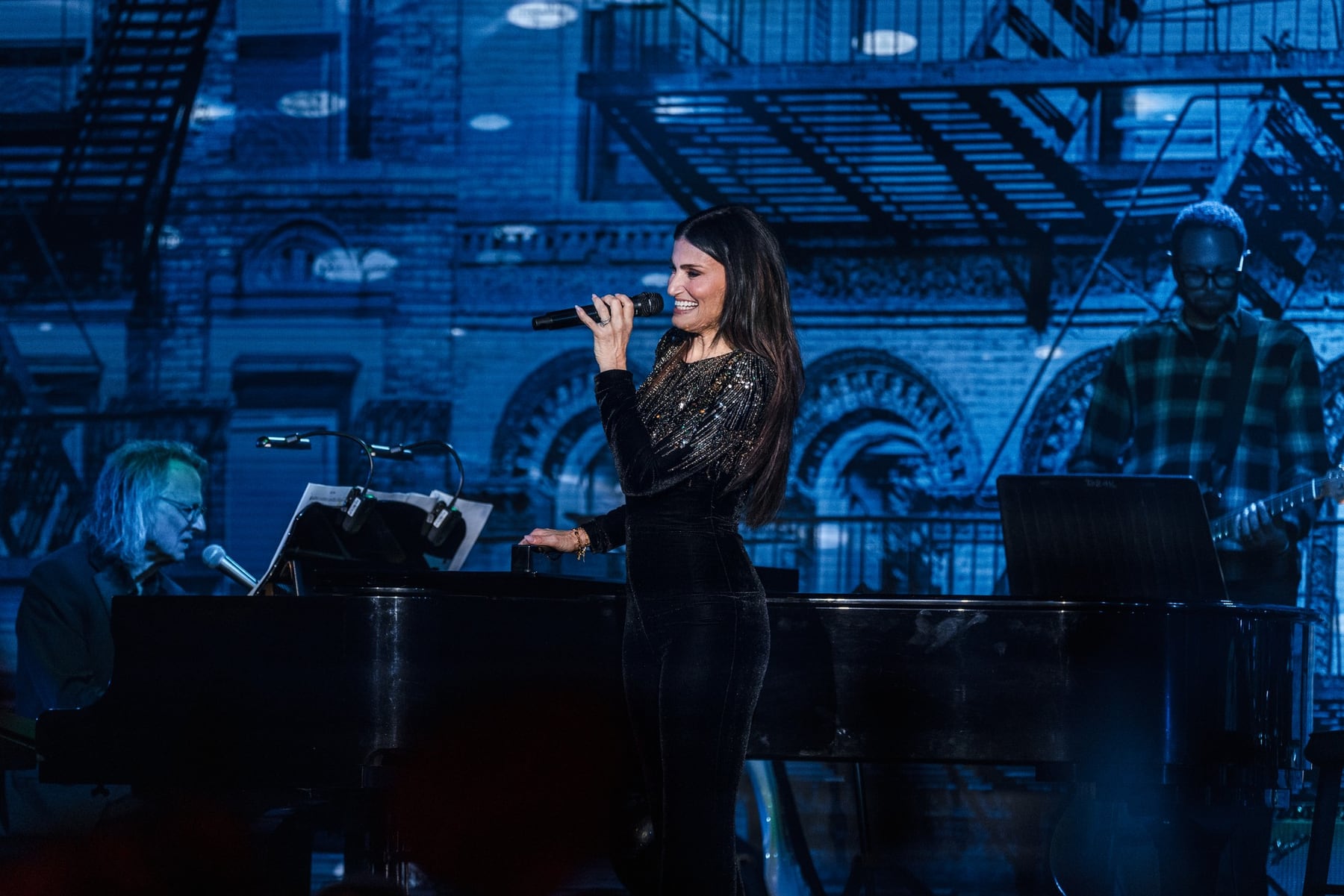 Idina Menzel performing with her band at a Travelers top-performer celebration