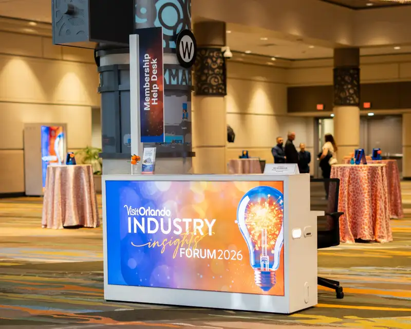 Visit Orlando registration desk and forum signage in the convention-center lobby.