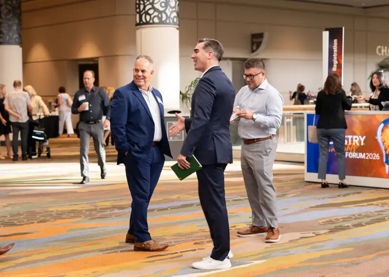 Attendees gather and talk in the convention-center lobby.