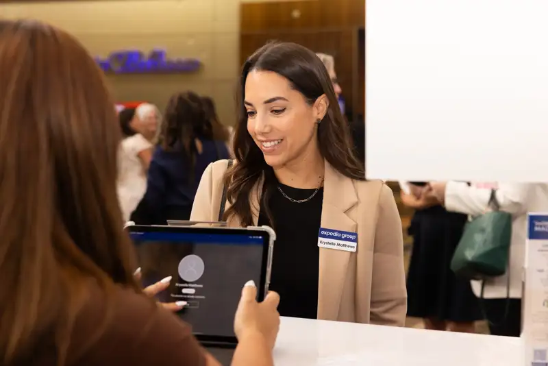 An attendee looks toward the program from a round table.
