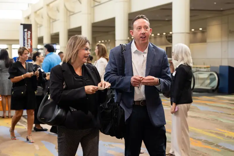 Guests and registration staff interact in the lobby.