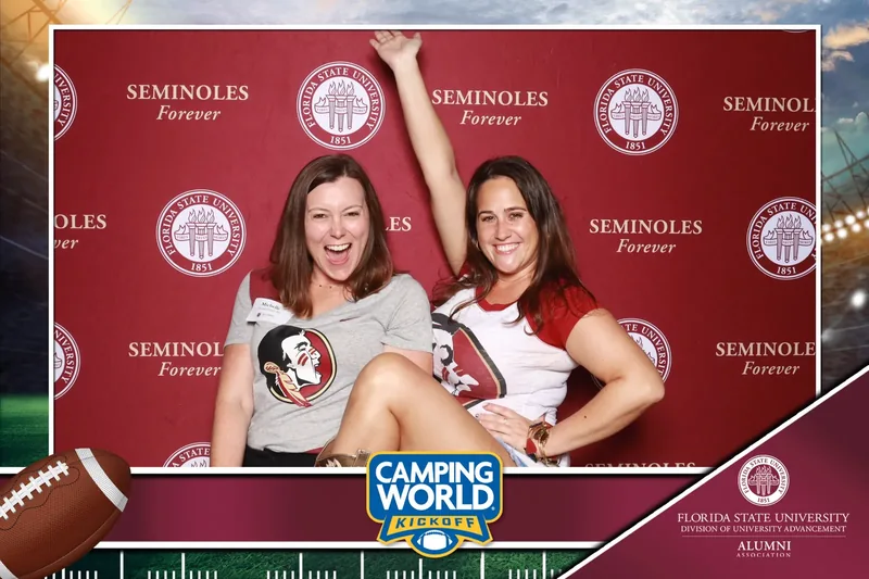Guests at a branded sponsor step-and-repeat photo activation at a corporate event in Orlando