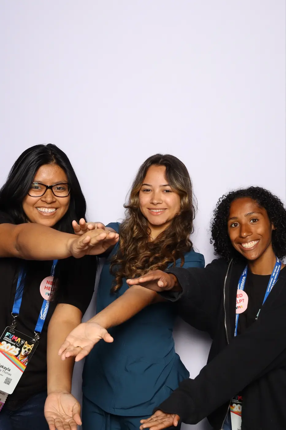 Three FVMA attendees showing off their hands during a fun group portrait