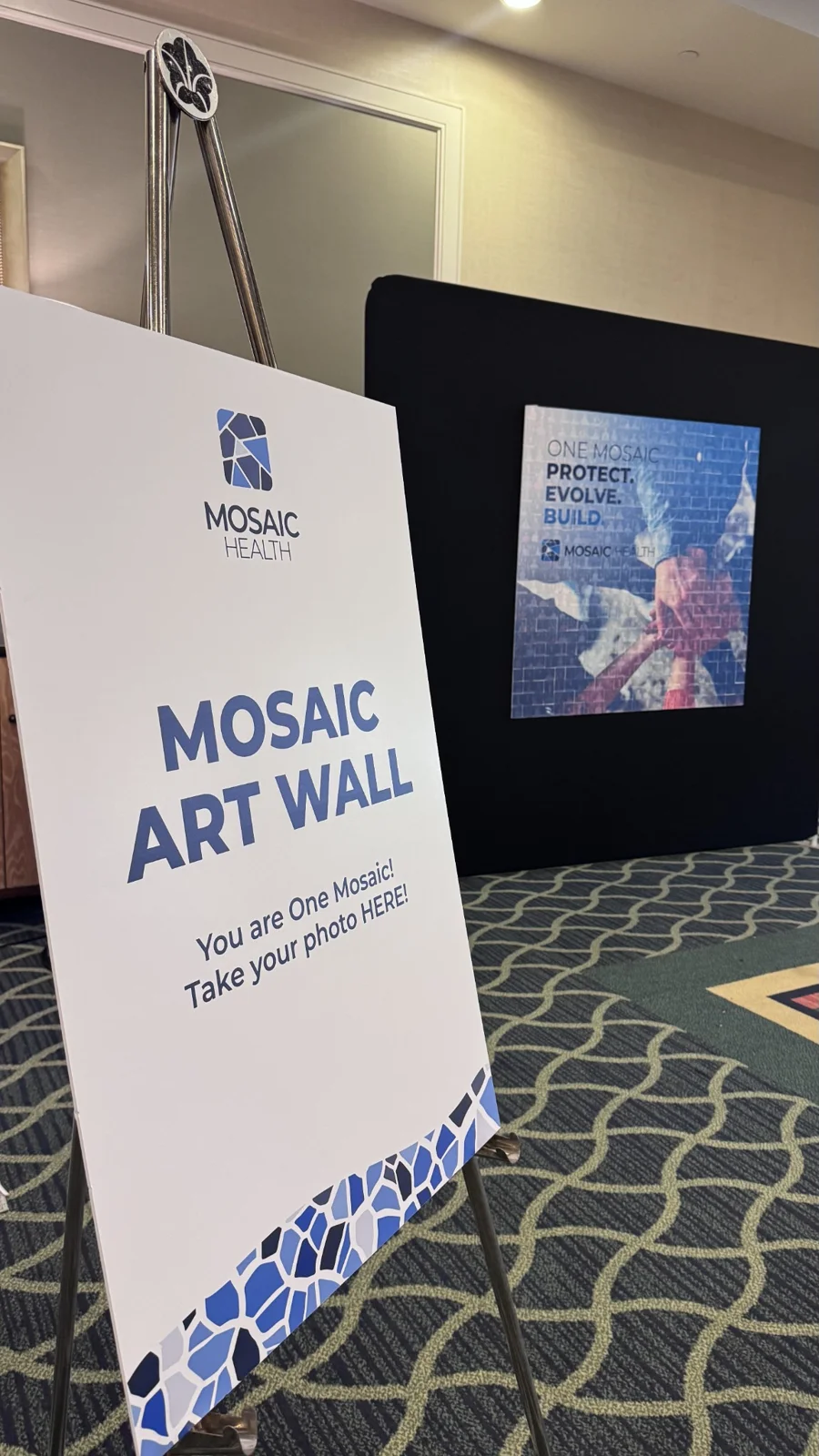 Mosaic Art Wall sign beside the Mosaic Health photo mosaic display