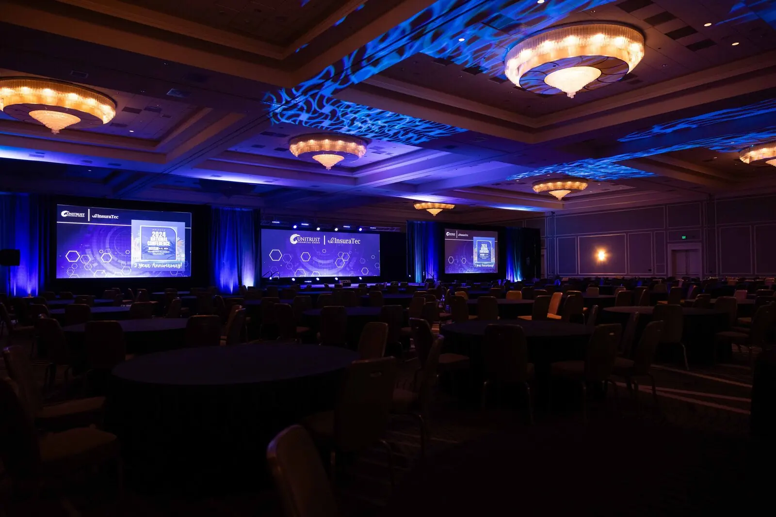 Atmospheric Orlando event photography of a corporate gala ballroom with dramatic lighting