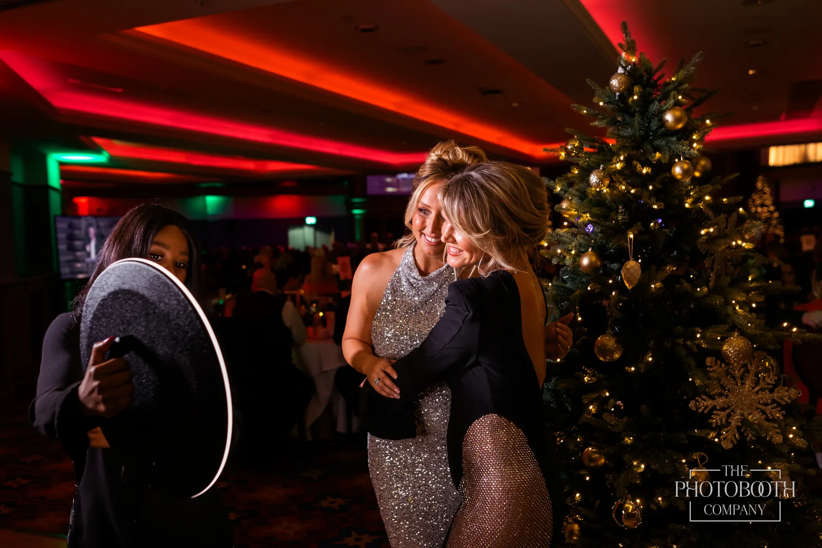 Roaming photo booth with a ring light capturing two guests sharing a candid moment at a corporate holiday gala